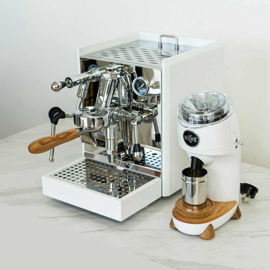 white espresso machine with a white niche grinder