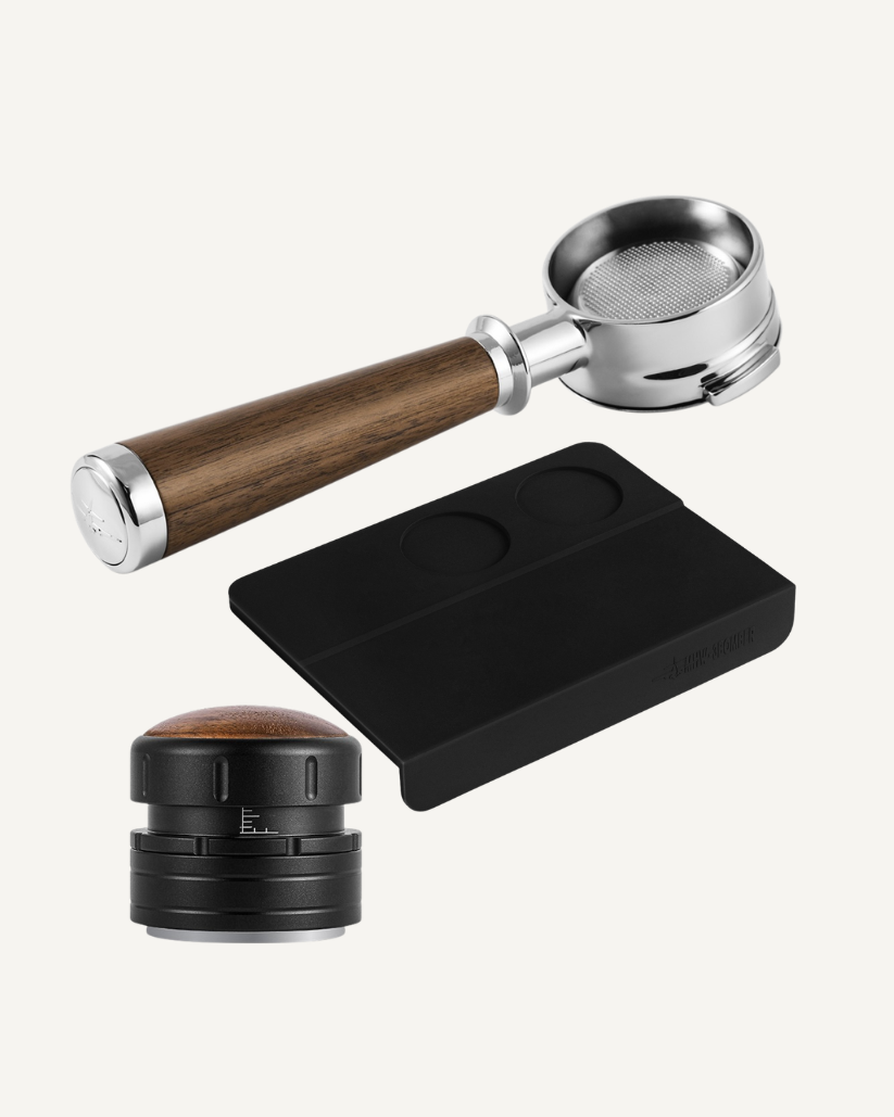 Coffee brewing tools including a tamper, portafilter, and tamping mat on a white background